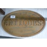 A cast iron plaque 'Antiques' 9'' x 14'