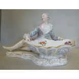 A 19thC Meissen porcelain recumbent figu