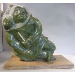 An Inuit carved and polished, green serp
