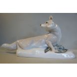 A porcelain model, a fox with a captured bird,