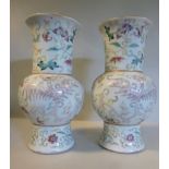 A pair of late 19thC Chinese porcelain bulbous vases, having wide, long necks and flared rims,