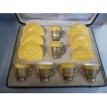 A presentation set of six Royal Doulton gilded ivory and mustard coloured glazed china coffee cups