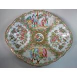 An early 20thC Canton porcelain oval, footed dish, decorated in reserves with figures, flora,