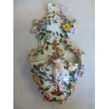 A late 19thC Continental scroll moulded, painted and floral encrusted porcelain wall pocket,