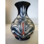 A Moorcroft pottery vase of squat, bulbous form, having a narrow neck and flared rim,