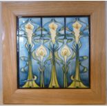 A Moorcroft pottery tile, decorated in Art Nouveau taste with tubelined, stylised lilies,