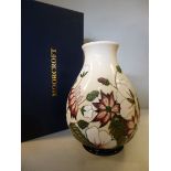 A Moorcroft pottery vase of ovoid form, decorated in tubeline with mixed flora and foliage,