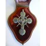 A white coloured metal and emerald green enamel pendant cross,