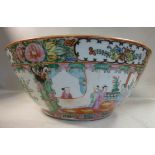 An early 20thC Canton porcelain footed bowl, decorated in reserves with figures, flora, birds,