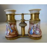 A pair of early 20thC French gilt metal opera glasses with turned ivory eyepiece surrounds,