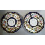 A pair of mid 19thC porcelain plates, decorated in reserves with floral sprigs and gilding,