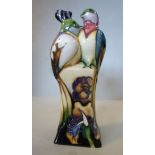 A Moorcroft pottery model, a pair of parrots perched on a square plinth,