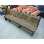 A late 19th/early 20thC pitch pine chapel pew with a level,