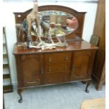 An early 20thC mahogany sideboard, having an oval mirror backed upstand,