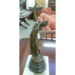 A cast and patinated bronze figure, a scantily clad woman,