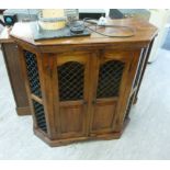 A modern Indonesian hardwood hexagonal cabinet with a pair of black painted metal,