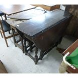 Two early 18thC oak drop leaf dining tables, each raised on turned, tapered,