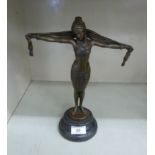 A cast and patinated bronze figure, an Art Deco inspired woman dancing,