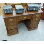 An early 20thC mahogany twin pedestal nine drawer desk,