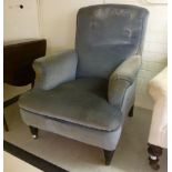 A late Victorian armchair upholstered in grey dralon, raised on ring turned, tapered,