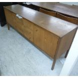 A 1970s Archie Shine teak sideboard, having three central drawers,