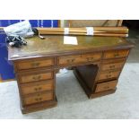 A late Victorian mahogany and satinwood nine drawer twin pedestal desk with a green hide scriber,