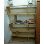 A modern pale oak living room unit with five open shelves,