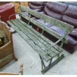 A mid 20thC wrought steel end garden bench with a wooden slatted back and seat 78''w CA