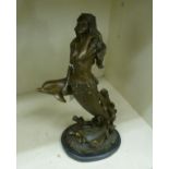 A cast and patinated bronze model, a mermaid and a dolphin,