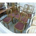 A set of eight early 20thC gilt painted Bentwood dining chairs, each with a padded seat,