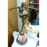 A cast bronze figure, an Art Deco style woman dancing,