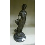 A cast and patinated bronze figure, an Art Nouveau style woman with a headband and a long dress,