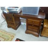 A modern mahogany six drawer twin pedestal desk,