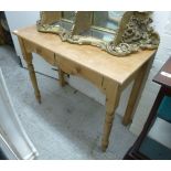 A 20thC waxed pine side table with two in-line drawers, raised on ring turned,