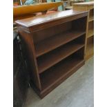 A modern figured walnut finished bookcase with two height adjustable shelves,