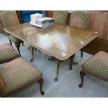 A modern oak extending dining table, having a crossbanded top, over opposing,