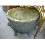 A composition stone garden planter, fashioned as a tree stump,