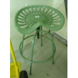 An (as new) green painted cast iron and steel stool with a height adjustable tractor style seat,