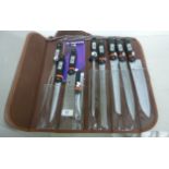 A nine piece kitchen knife set with steel handles,