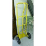 A yellow painted steel sack barrow BSR