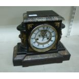 A late Victorian black painted breakfront mantel clock of architectural form;