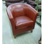 A modern red hide upholstered tub design chair,