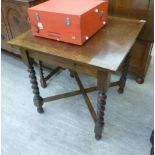 A 1920s oak dining table, the square top raised on barleytwist supports and block legs,