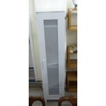 An Ikea white painted wardrobe with a frosted plastic panelled door,