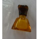 An amber scent bottle of triangular form with a detachable lid 1.