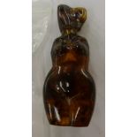 An amber scent bottle, fashioned as a woman's body with a detachable lid 3.