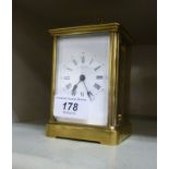 An early 20thC brass cased carriage clock; the movement faced by a white enamelled Roman dial 4.