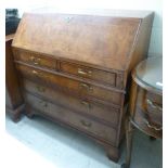 A modern burr walnut finished George II inspired bureau with two short/three graduated long drawers,