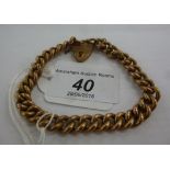 A 9ct gold hollow curb link bracelet with a heart shaped clasp 11