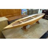 A 20thC carved fruitwood model, a canoe,